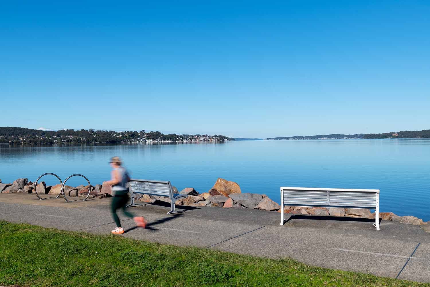 Runner enjoying the lakeside shared pathway between Warners Bay and Speers Point on Lake Macquarie.