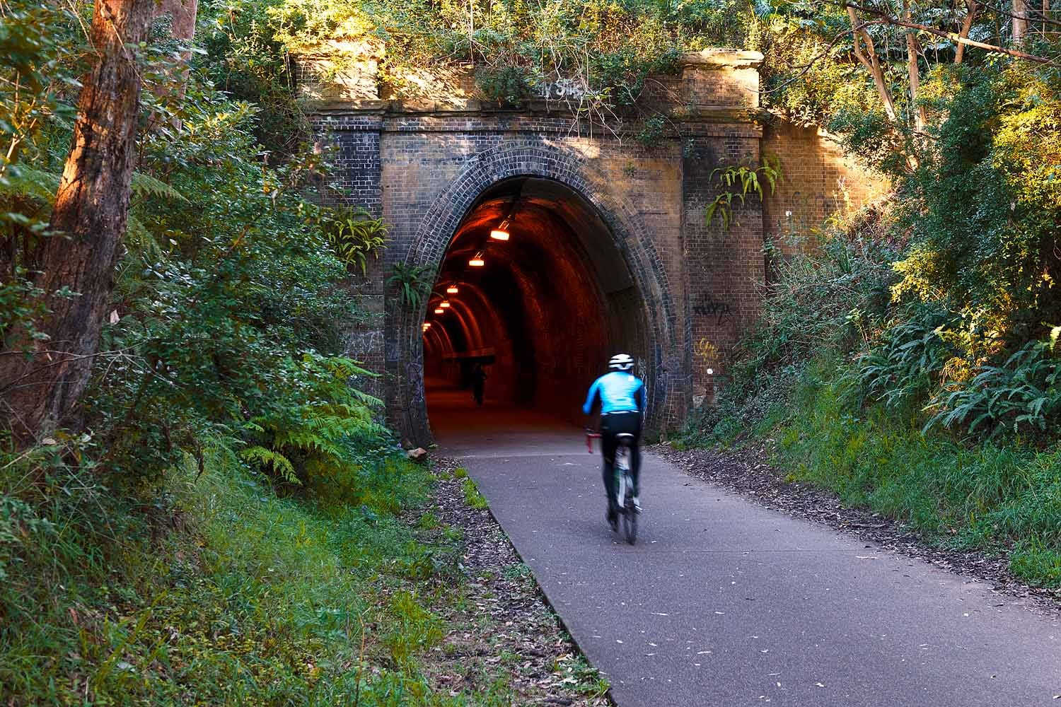 Cyclist entering the heritage Fernleigh Track Tunnel on the Fernleigh Track between Newcastle and Lake Macquarie.
