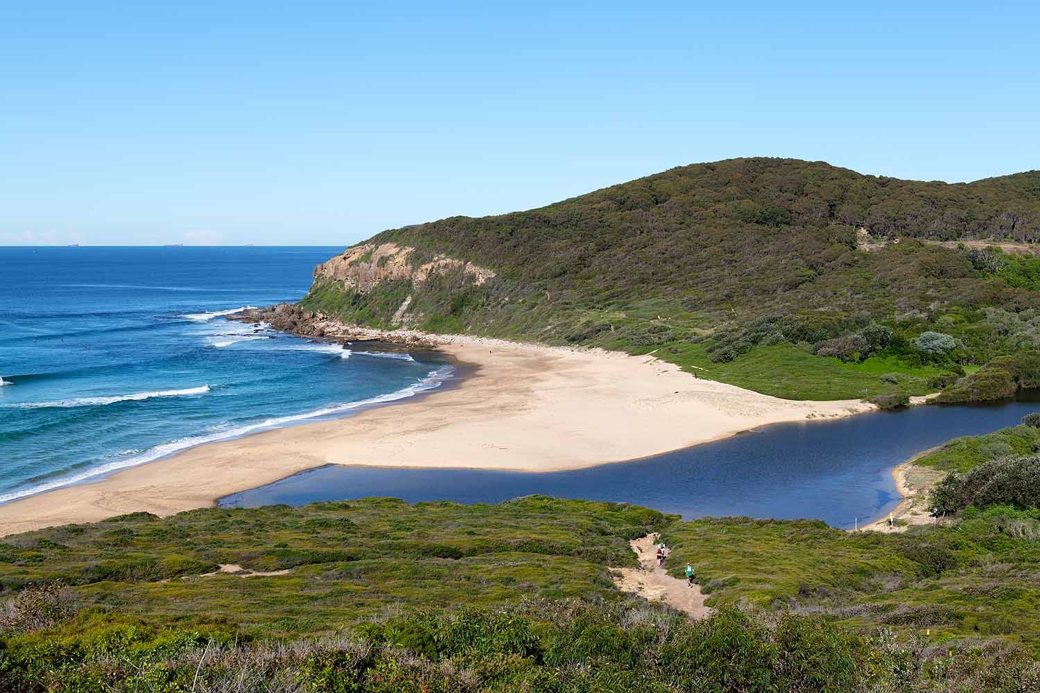 Glenrock Lagoon meets Burwood Beach in Glenrock State Conservation Area, Newcastle, with coastal heathland, sandstone headlands and ocean views along the popular Yuelarbah Walking Track.