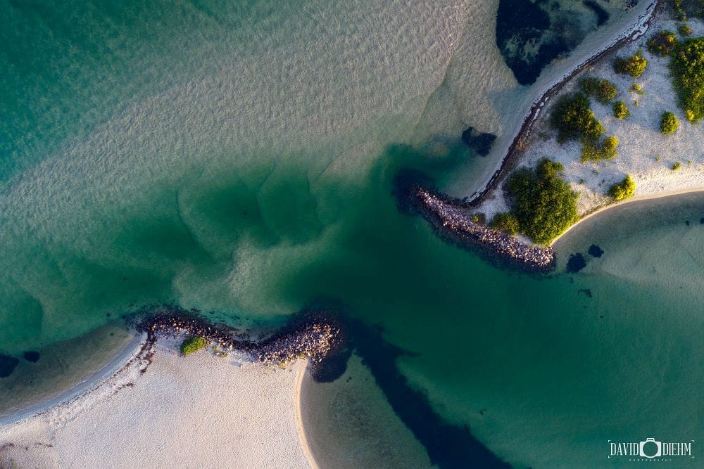 Aerial view of turquoise channels and sand formations near Naru Beach Lake Macquarie