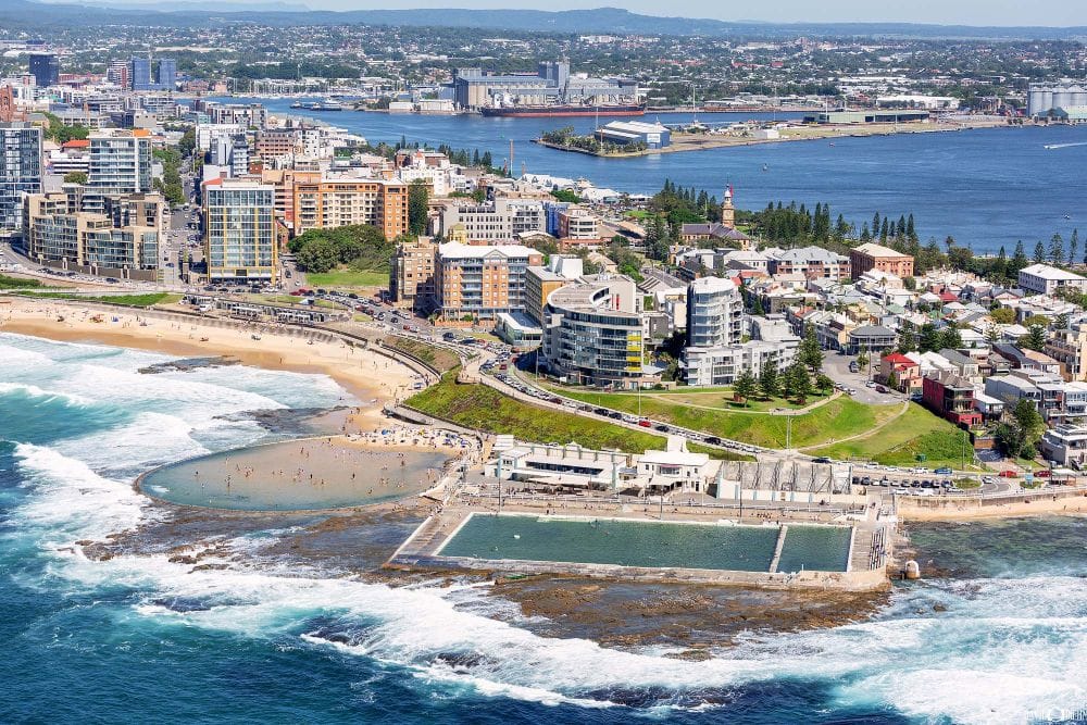 newcastle-ocean-baths-aerial-newcastle-beach.jpg Aerial view of Newcastle Ocean Baths beside Newcastle Beach with Newcastle Harbour and the city skyline in the background.
