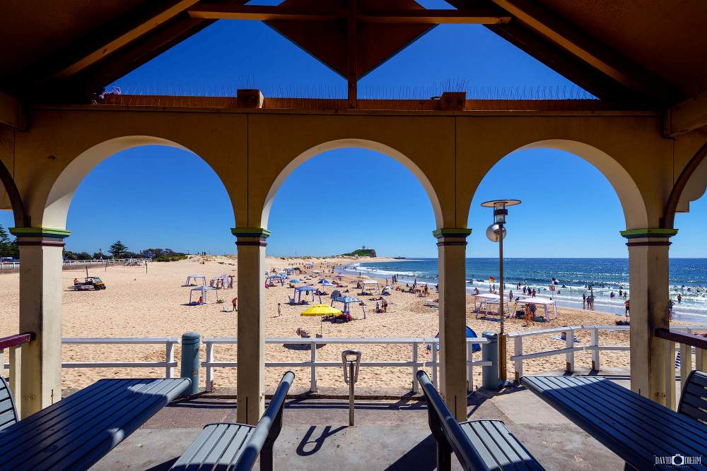 nobbys-beach-pavilion-view-newcastle.jpg View from the historic Nobbys Beach Pavilion overlooking the sand, ocean and Nobbys Lighthouse in Newcastle NSW.