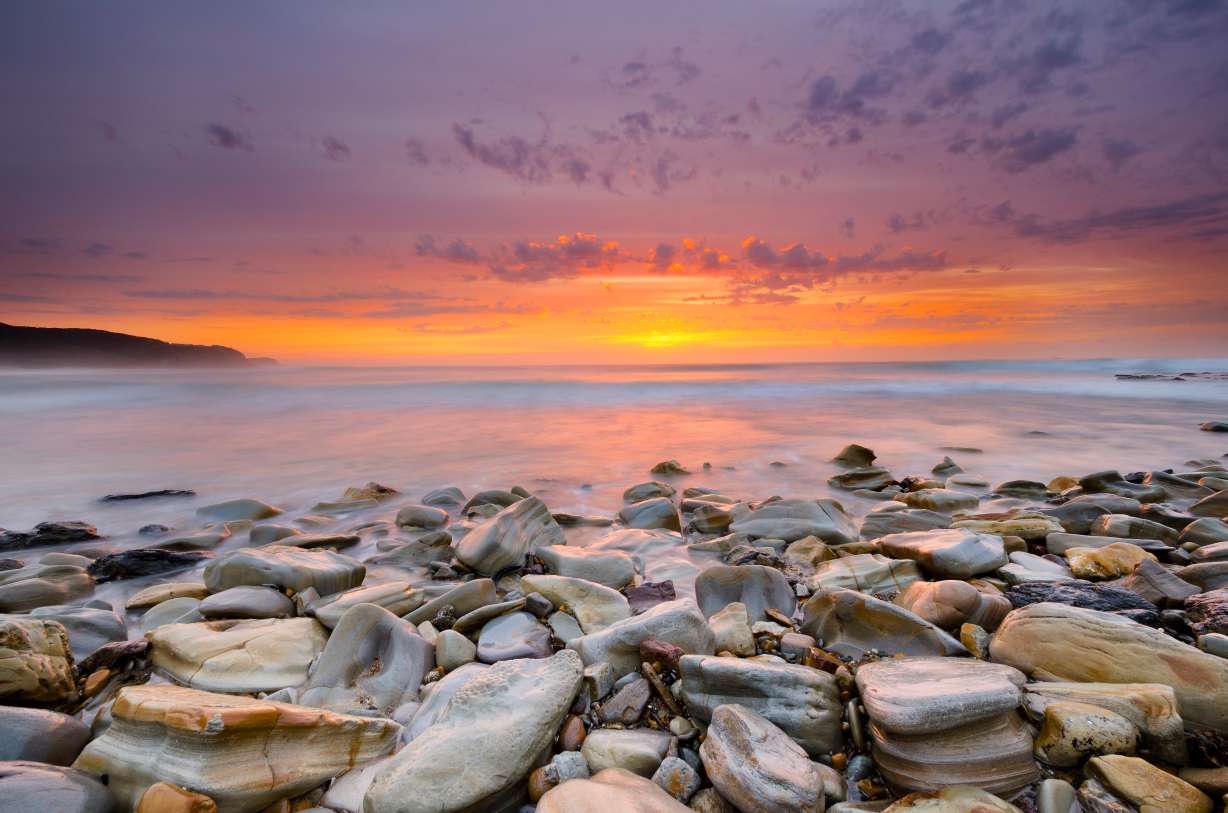Sunrise over the sandstone rock platforms at Burwood Beach in Glenrock State Conservation Area, Newcastle, NSW.