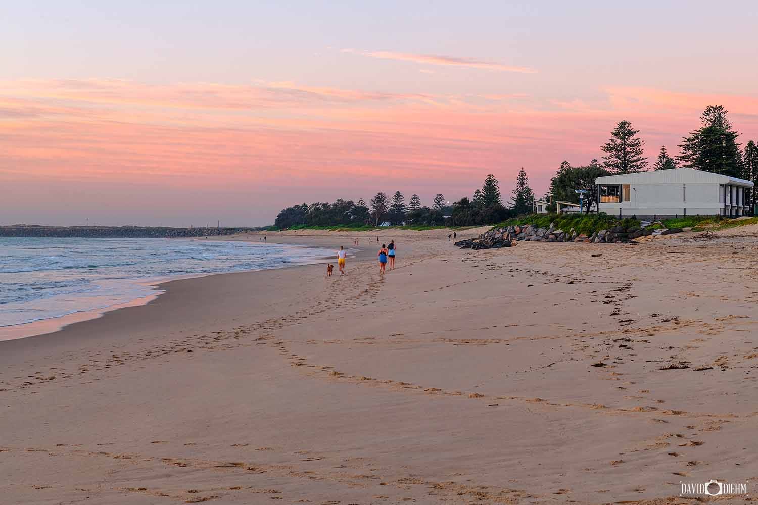 stockton-beach-sunset-newcastle.jpg Pastel sunset colours over Stockton Beach with walkers enjoying the shoreline near Newcastle.