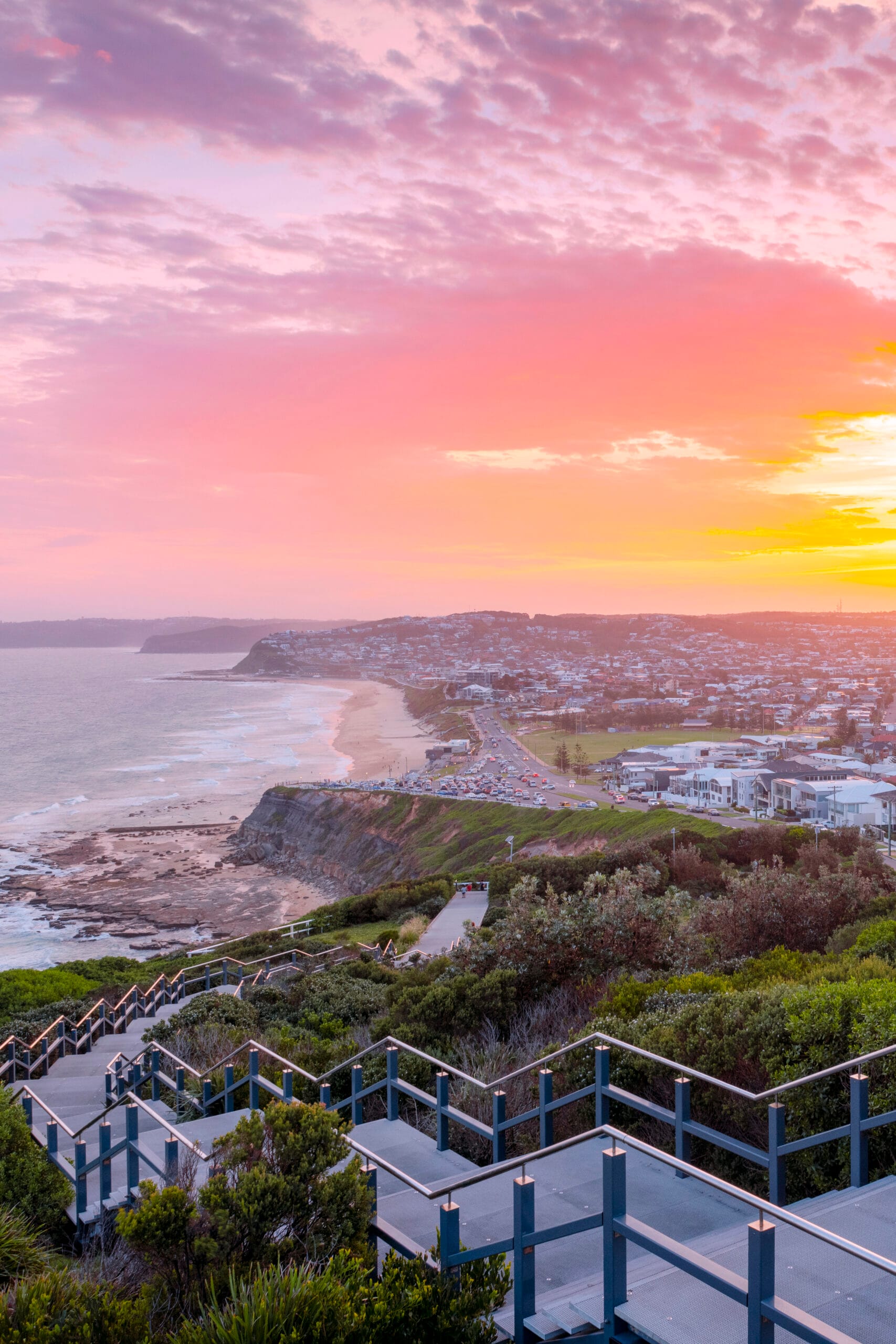 Sunrise over ANZAC Memorial Walk overlooking Bar Beach and Newcastle's coastline in NSW.