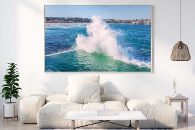 Framed Bondi Icebergs wave photograph displayed as coastal wall art in a contemporary living room.