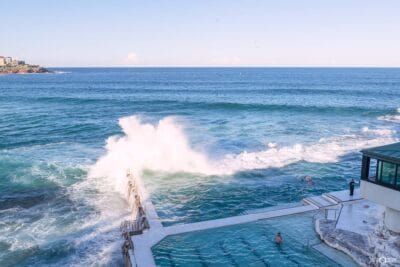 Powerful surf crashes into Bondi Icebergs Ocean Pool overlooking the Pacific Ocean in Sydney, NSW.