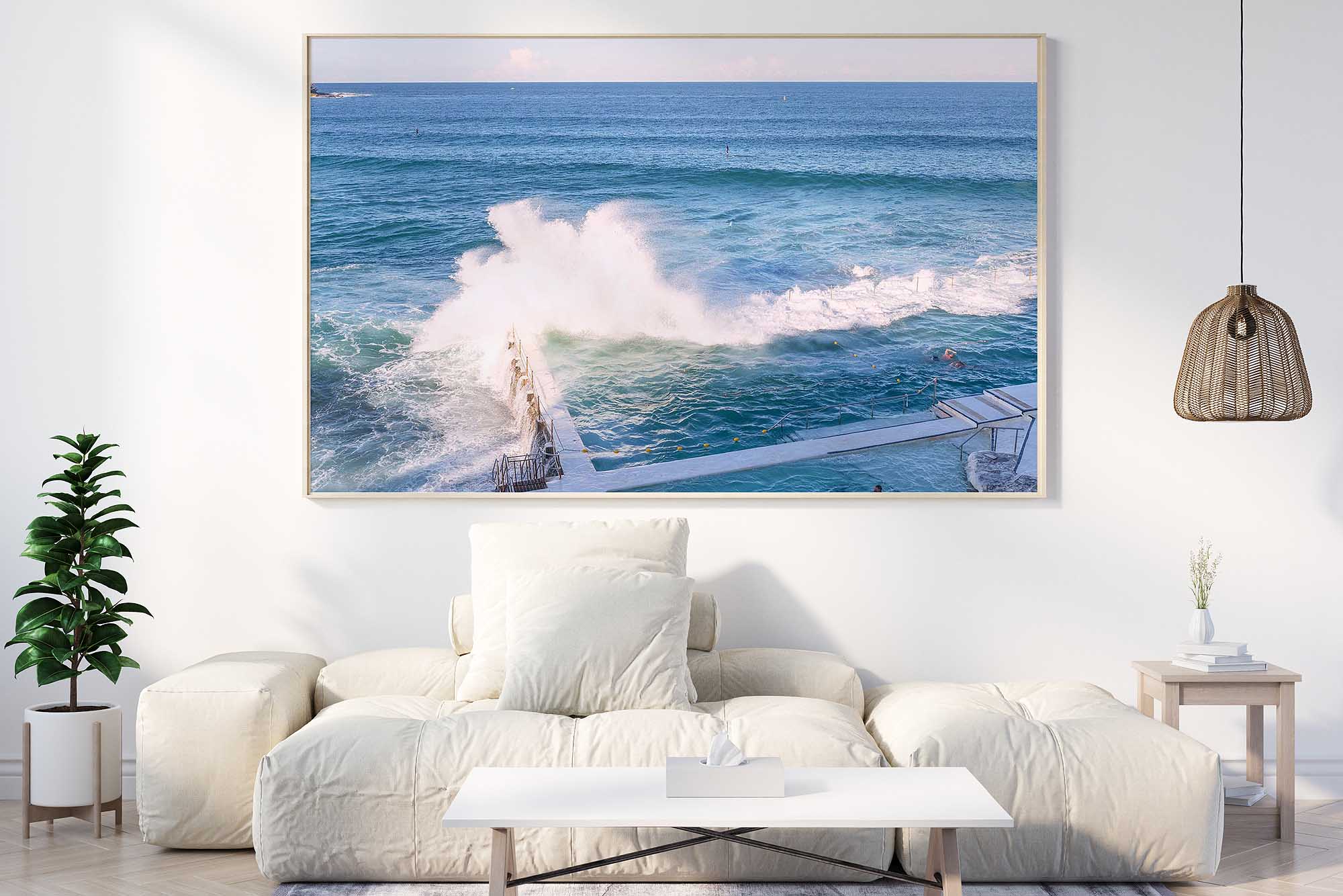 Framed Bondi Icebergs Ocean Pool wave photograph displayed as coastal wall art in a contemporary living room.