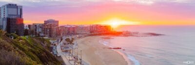 Panoramic sunrise overlooking Newcastle Beach, Newcastle Ocean Baths and the Newcastle coastline in NSW.