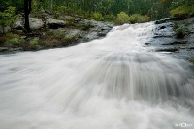 Flowing waterfall at Flaggy Creek in Glenrock State Conservation Area along the Yuelarbah Track near Newcastle NSW.