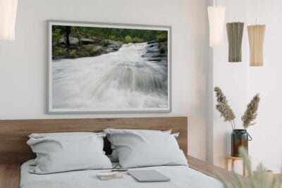 Framed wall art featuring Flaggy Creek waterfall in Glenrock State Conservation Area displayed in a modern bedroom.