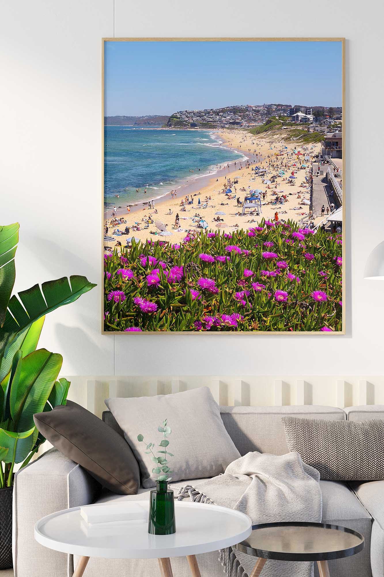 Bar Beach Newcastle photography print showing the beach, blue ocean and colourful flowers, displayed as framed wall art.