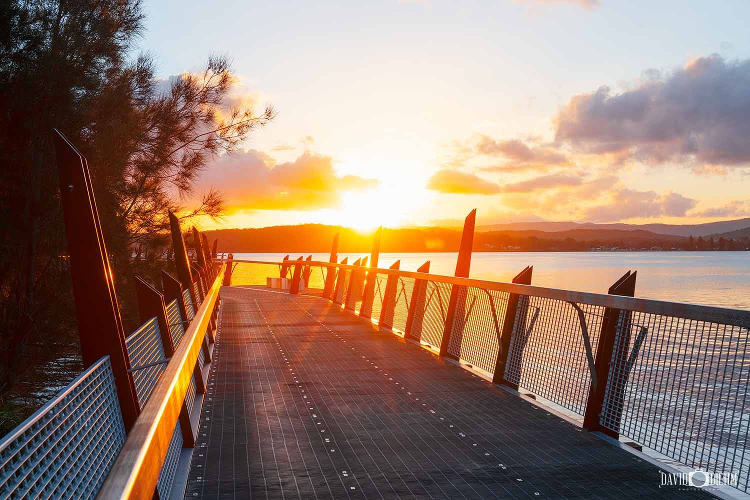 red-bluff-boardwalk-sunset.jpg Sunset glowing across the Red Bluff Boardwalk and Lake Macquarie.