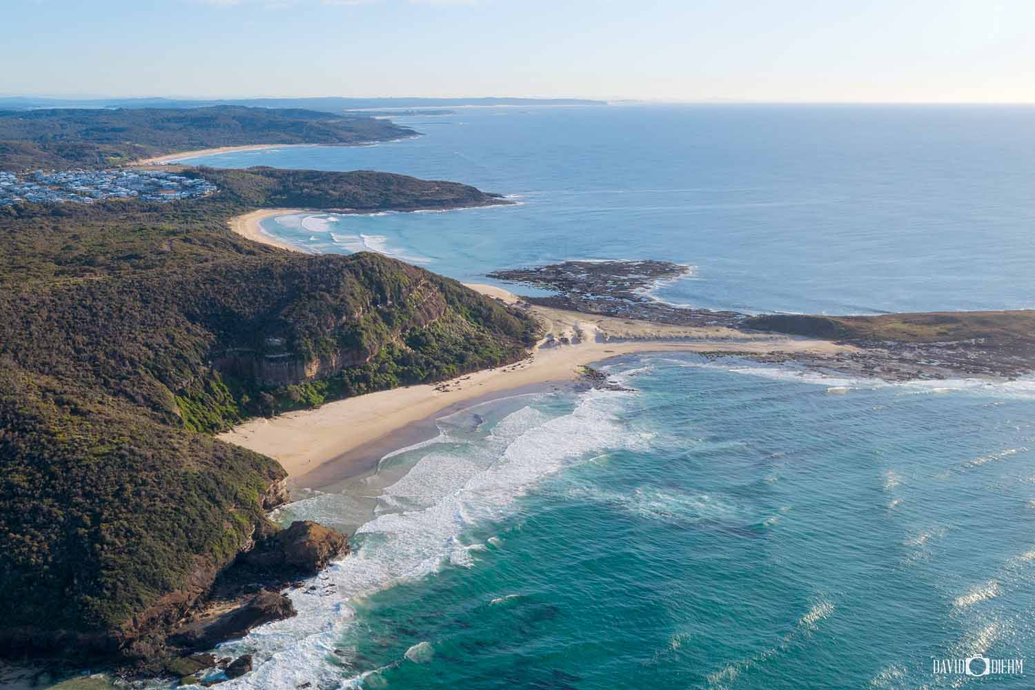 Aerial view of Ghosties Beach and the coastal walk in Lake Macquarie, NSW.