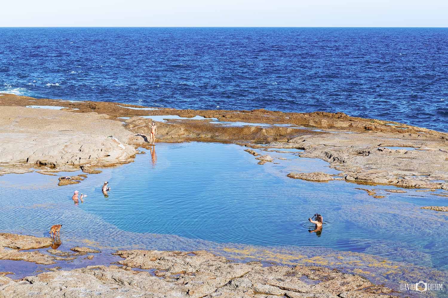 catherine-hill-bay-rock-pools-swimming.jpg People swimming in a large natural rock pool beside the ocean at Catherine Hill Bay