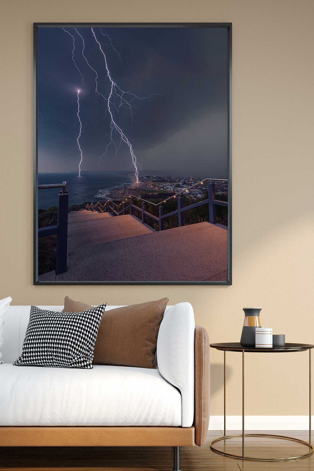 Newcastle photography wall art print featuring a lightning storm over the coastline displayed in a living room