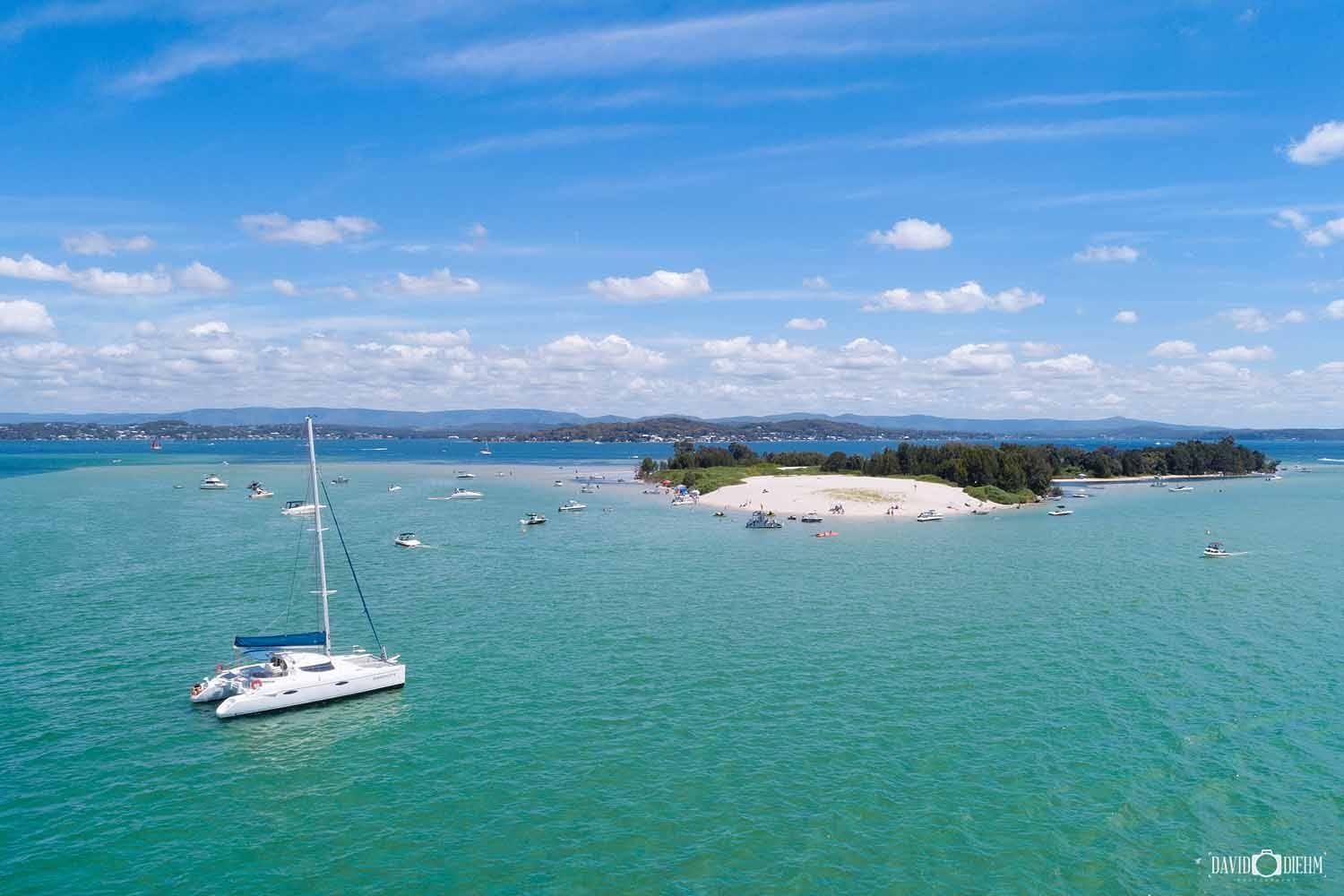 swansea-sand-islands-lake-macquarie.jpg Aerial view of a Swansea sand island and yacht on the turquoise waters of Lake Macquarie.