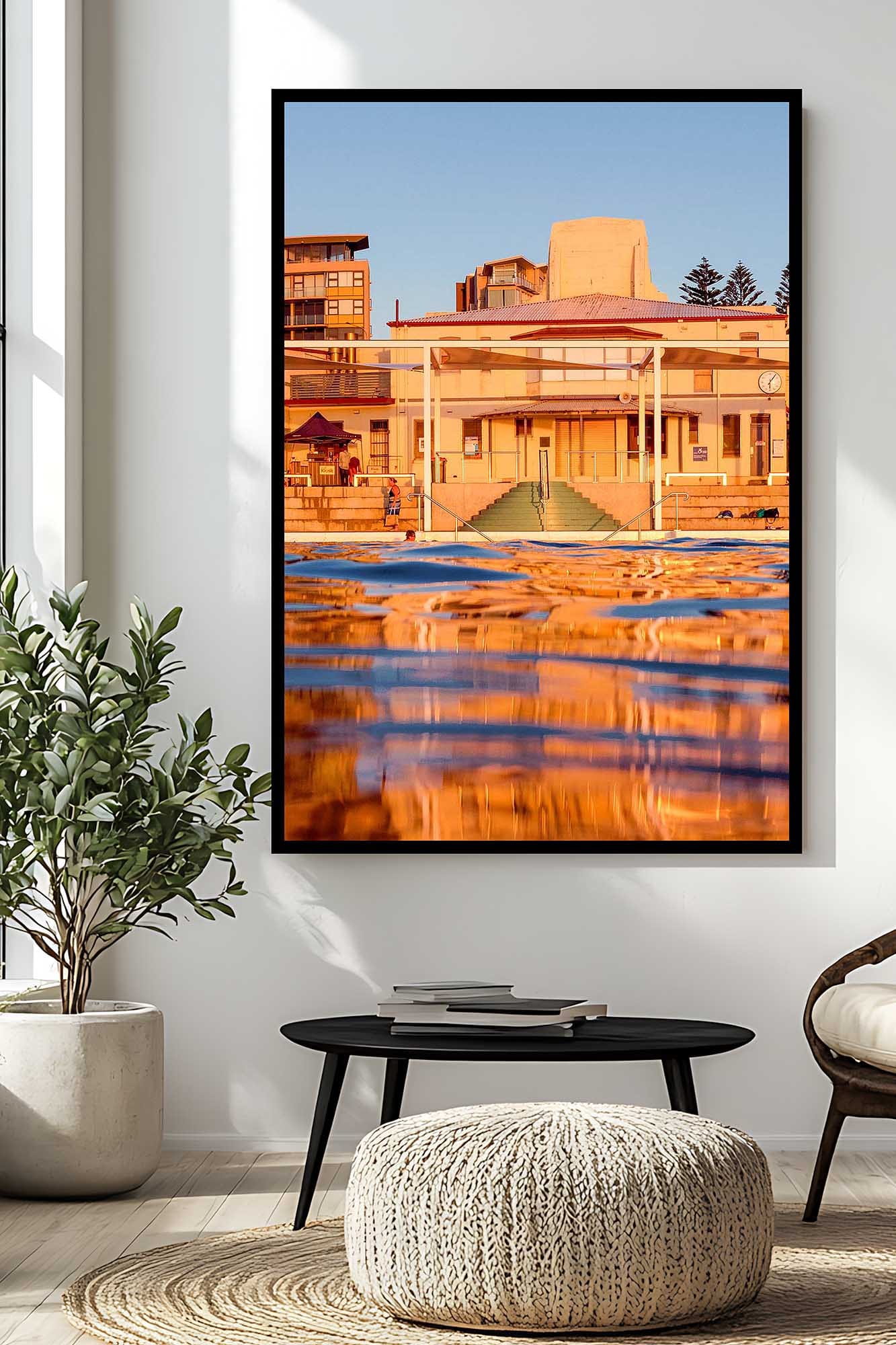 Newcastle Ocean Baths photography print capturing the historic pavilion reflected in the ocean pool at golden hour.