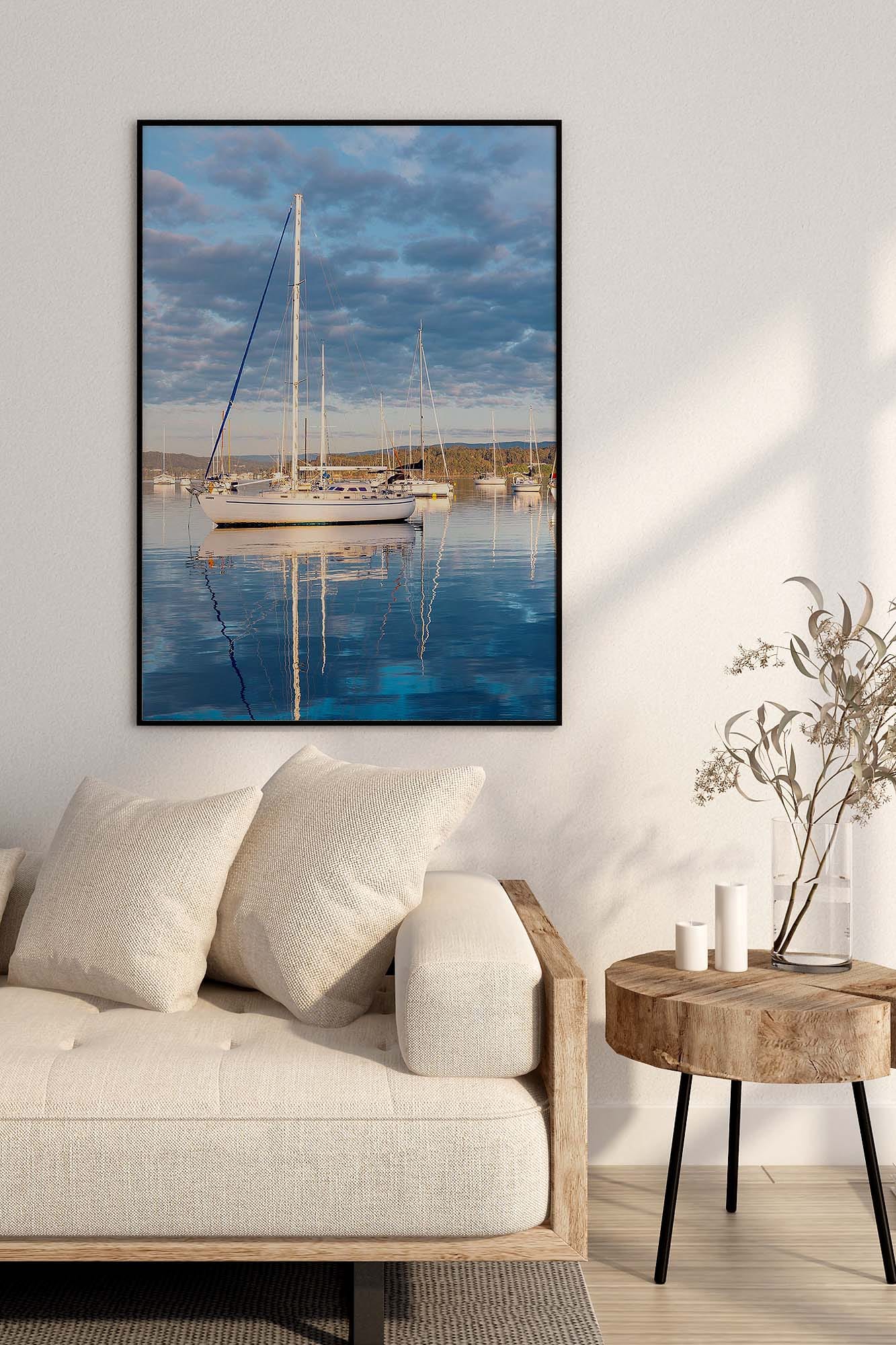 Valentine Lake Macquarie photography print featuring a yacht reflected on calm water displayed in a coastal living room