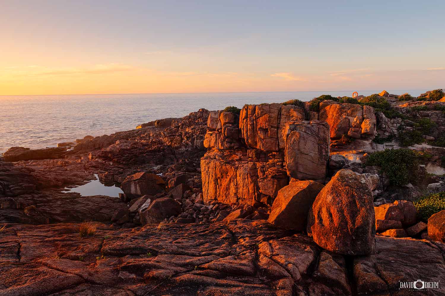 Rocky coastline at Boat Harbour glowing in the warm sunset light