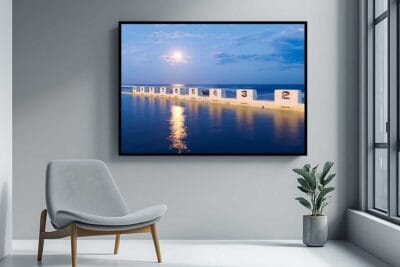 Merewether Moonlight photographic print displayed as large framed wall art in a modern living room.